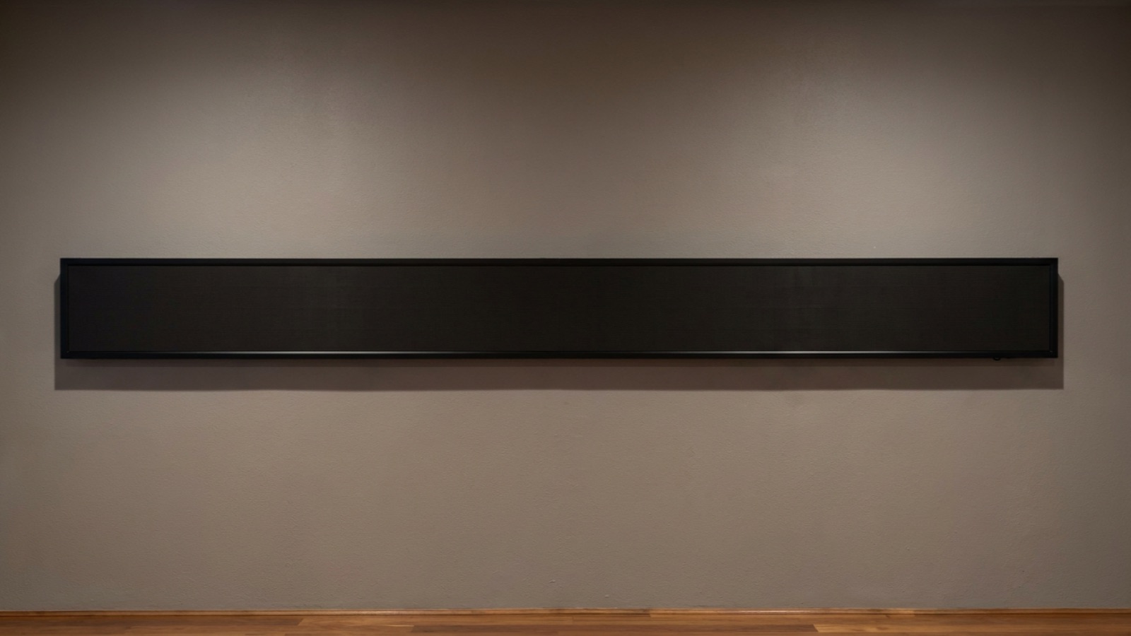 A 3-metre Cove Live LED ticker strip mounted on a wall, showing the live feed